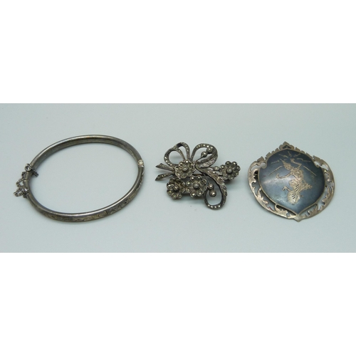 1036 - A silver bangle, a marcasite set silver brooch and a Siam silver brooch, 23.9g