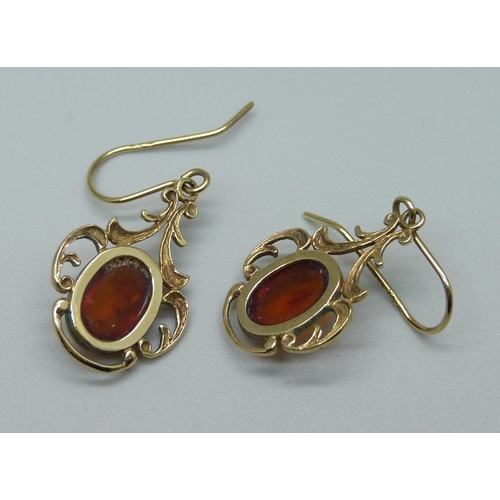 1064 - A pair of 9ct gold amber earrings, 3.6g