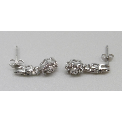 1065 - A pair of 9ct white gold and diamond earrings, 3.1g