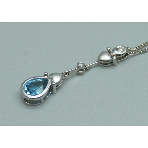 1082 - An 18ct white gold pendant on an 18ct white gold chain, set with a blue stone and diamond, 5g, chain... 