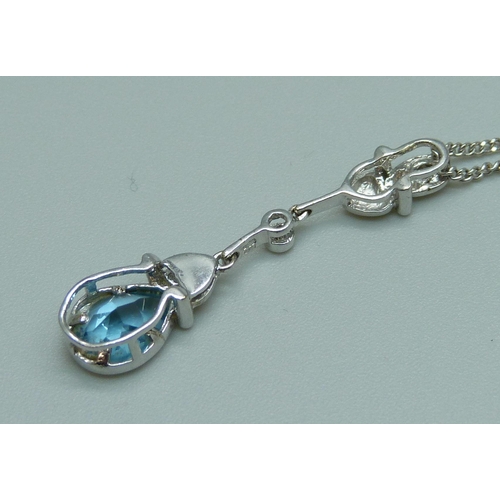 1082 - An 18ct white gold pendant on an 18ct white gold chain, set with a blue stone and diamond, 5g, chain... 