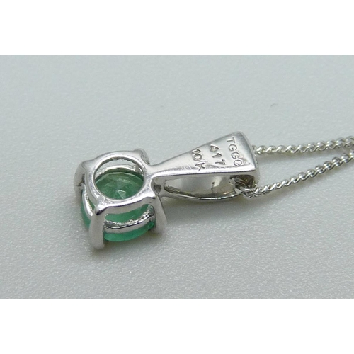 1083 - A 10ct white gold and emerald pendant on chain, 1.6g, chain 43cm