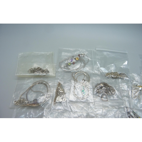 1122 - Twenty silver pendants and chains