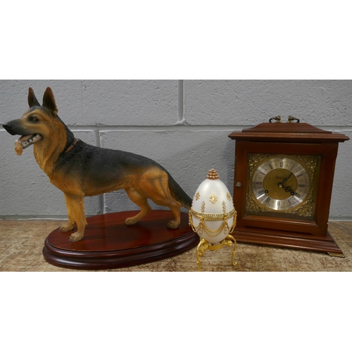 1139 - A Metamec wooden cased clock, a model of a German Shepherd and a decorative egg **PLEASE NOTE THIS L... 