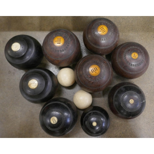 1193 - Three sets of three lawn bowls and a box of assorted items, Chinese plates, metal dog door stop, tra... 