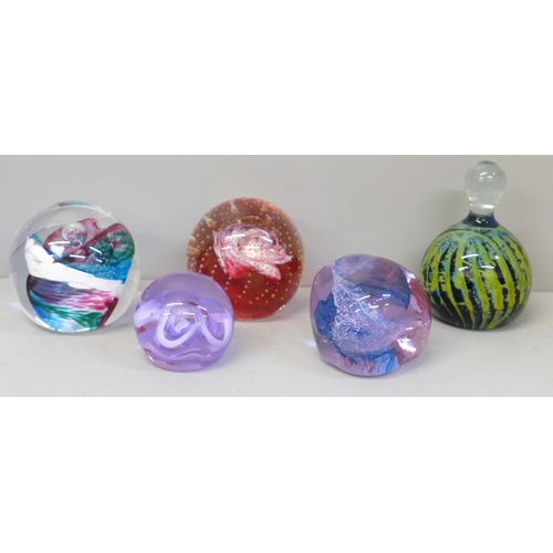 658 - A collection of four Caithness and one Mdina glass paperweights