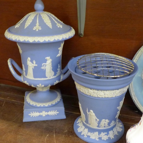 676 - A Wedgwood Jasperware urn, a flower frog and vase, a mantel clock, a similar style collector's plate... 