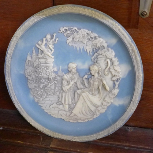 676 - A Wedgwood Jasperware urn, a flower frog and vase, a mantel clock, a similar style collector's plate... 