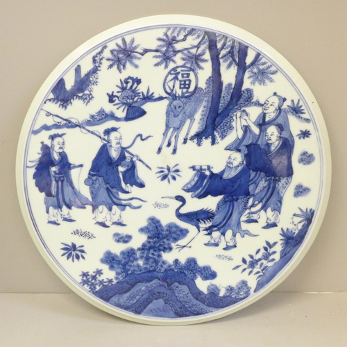 706 - A Chinese circular blue and white plaque, 31.5cm