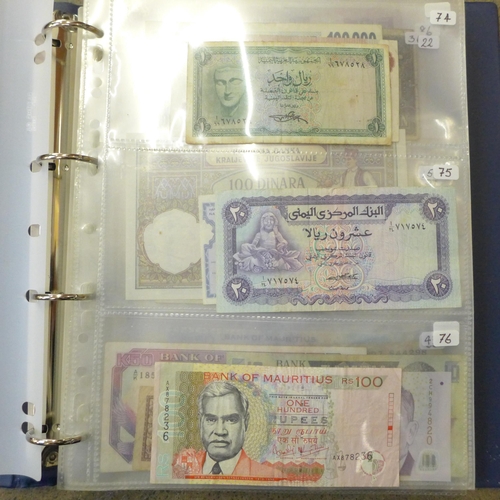 762 - A blue album of circulated bank notes, Maruitius, Singapore, Zambia, etc.