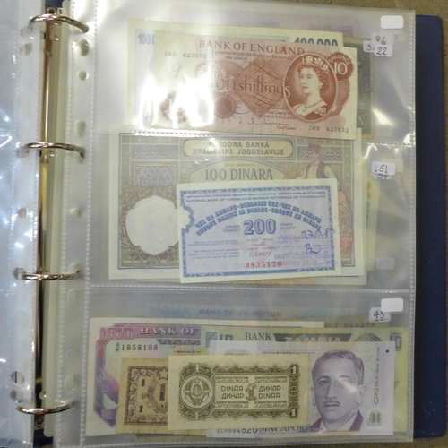 762 - A blue album of circulated bank notes, Maruitius, Singapore, Zambia, etc.