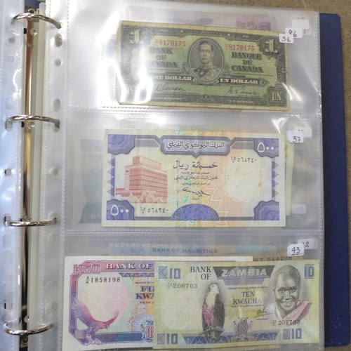 762 - A blue album of circulated bank notes, Maruitius, Singapore, Zambia, etc.