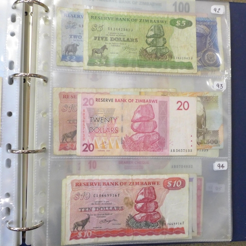 762 - A blue album of circulated bank notes, Maruitius, Singapore, Zambia, etc.