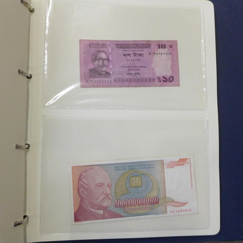 762 - A blue album of circulated bank notes, Maruitius, Singapore, Zambia, etc.