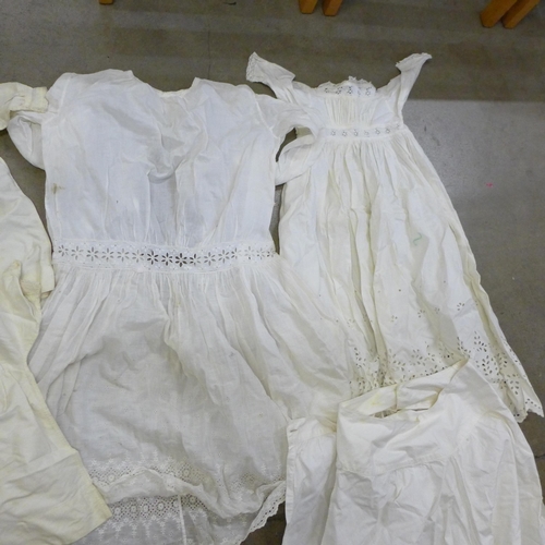 776 - A collection of lace items including christening gowns and other early 20th Century clothing