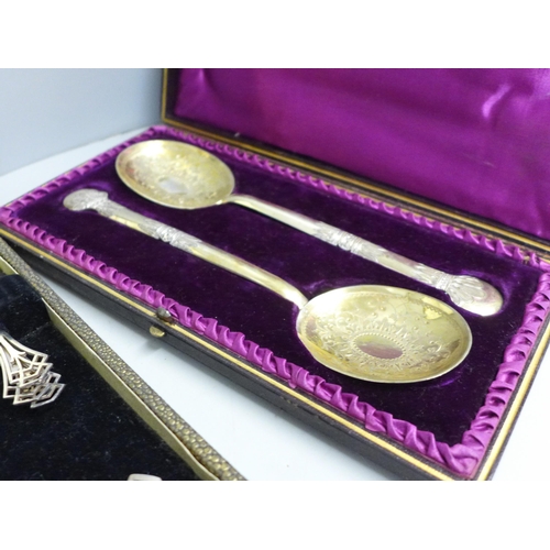 785 - A cased pair of large engraved plated spoons and two other cased silver plated flatware sets