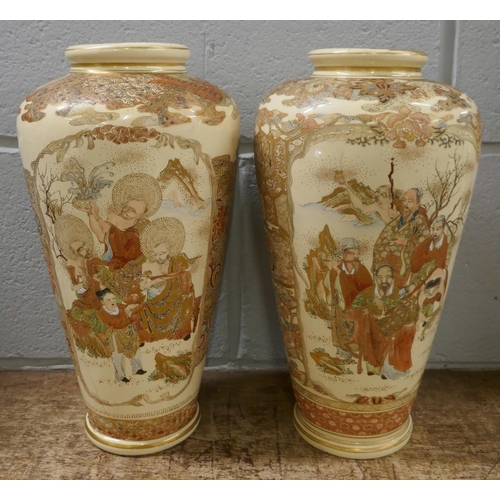 806 - A pair of Japanese Meiji period Satsuma vases decorated in enamels and gilt, painted all over with s... 