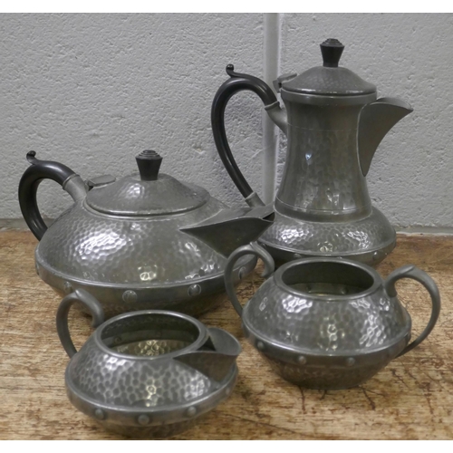 810 - A Craftsman Arts and Crafts four piece hammered pewter tea service