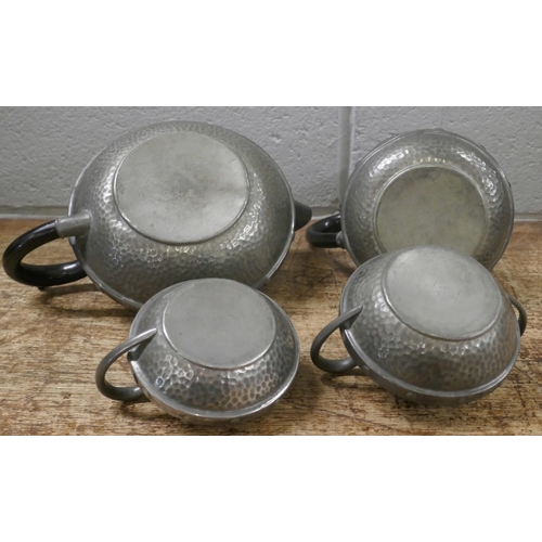 810 - A Craftsman Arts and Crafts four piece hammered pewter tea service