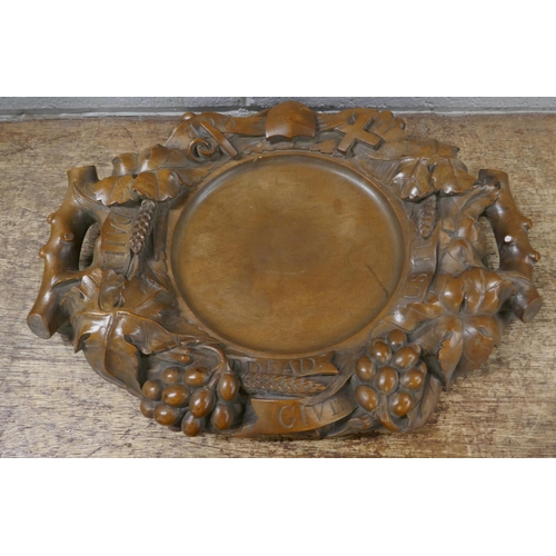 828 - A carved walnut religious collection tray, 'Give Us This Day Our Daily Bread', 43cm