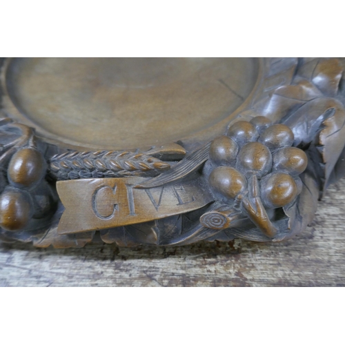 828 - A carved walnut religious collection tray, 'Give Us This Day Our Daily Bread', 43cm