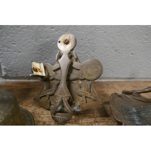 829 - A collection of metal items including an Art Nouveau style figural dish, a bell, jug, etc.