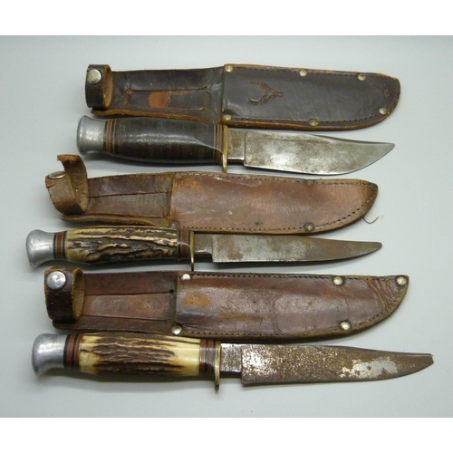 858 - Three hunting knives with scabbards, one marked Rodgers, Sheffield