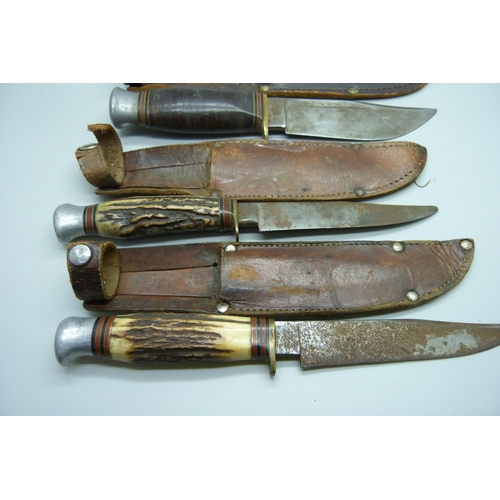 858 - Three hunting knives with scabbards, one marked Rodgers, Sheffield