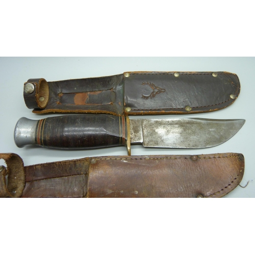 858 - Three hunting knives with scabbards, one marked Rodgers, Sheffield