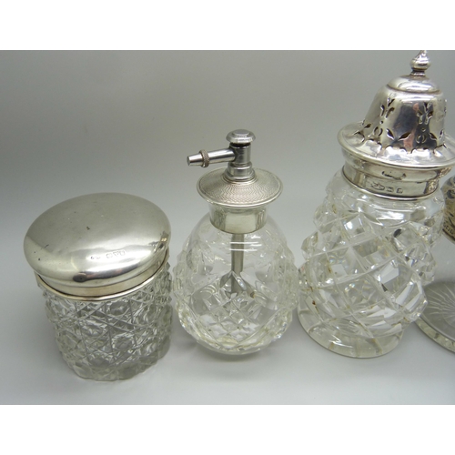 876 - A cut glass sugar caster with silver top, Birmingham 1928, a silver topped perfume atomiser, two sil... 