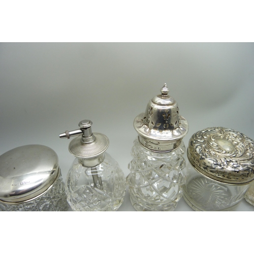 876 - A cut glass sugar caster with silver top, Birmingham 1928, a silver topped perfume atomiser, two sil... 