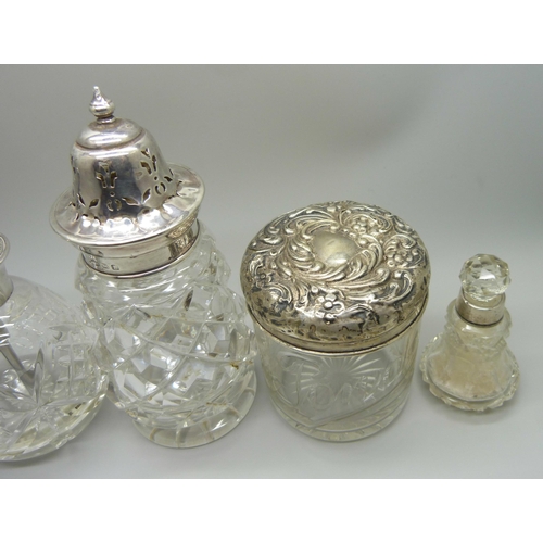 876 - A cut glass sugar caster with silver top, Birmingham 1928, a silver topped perfume atomiser, two sil... 