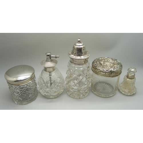 876 - A cut glass sugar caster with silver top, Birmingham 1928, a silver topped perfume atomiser, two sil... 