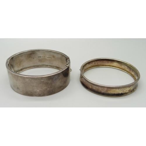 894 - Two silver bangles, one by Walker & Hall, 46g