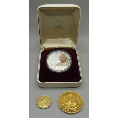 895 - A boxed silver one dollar Pope John Paul II coin, a $10 Liberia silver coin and an 1887 Victoria The... 