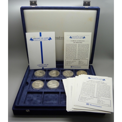 900 - A box of Westminster vintage motor vehicle coins, (18), and a box of one crown coins celebrating dif... 