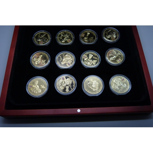 900 - A box of Westminster vintage motor vehicle coins, (18), and a box of one crown coins celebrating dif... 