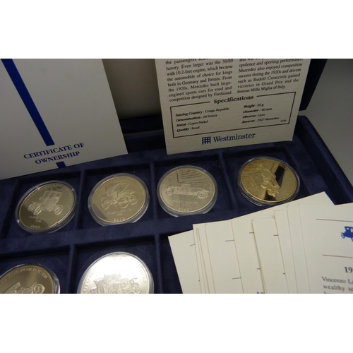 900 - A box of Westminster vintage motor vehicle coins, (18), and a box of one crown coins celebrating dif... 