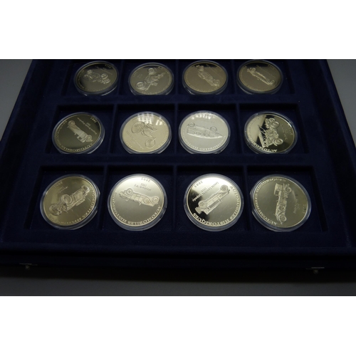 900 - A box of Westminster vintage motor vehicle coins, (18), and a box of one crown coins celebrating dif... 