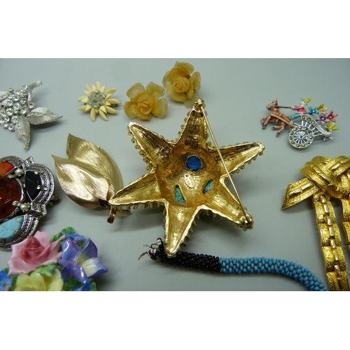 917 - Costume jewellery including a Benedikt, NY, starfish brooch, a gold tone Crosse brooch, etc.