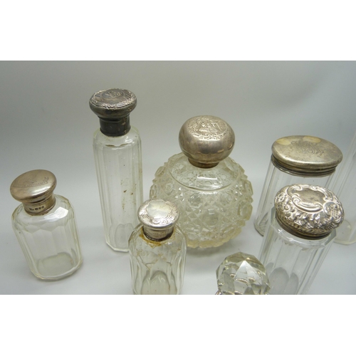 918 - A collection of silver topped bottles and jars and a silver mounted comb, some a/f