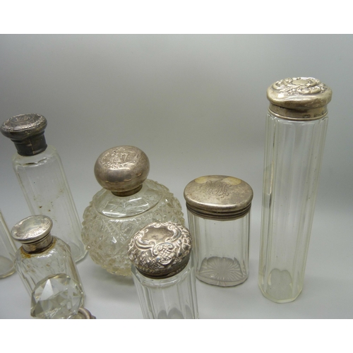 918 - A collection of silver topped bottles and jars and a silver mounted comb, some a/f