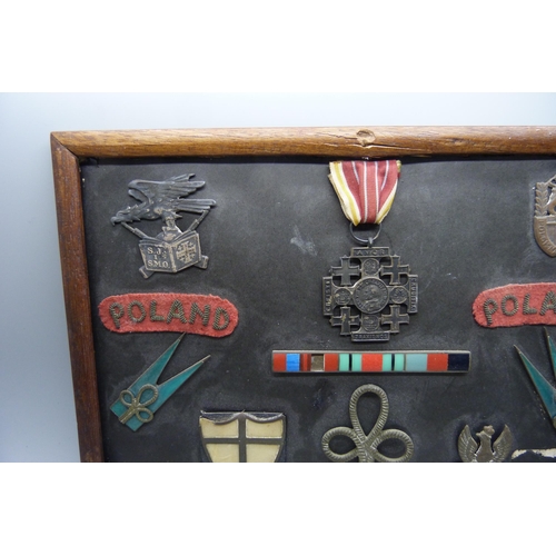 928 - A framed selection of Polish WW2 badges, medal and insignia relating to the 2nd Polish Corps includi... 