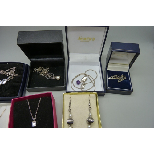 936 - A collection of silver jewellery, pendants, earrings and a ring