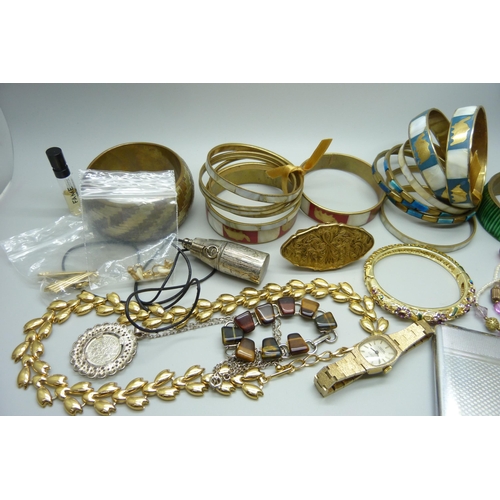 952 - A collection of costume jewellery including bangles, a Montine wristwatch, earrings, case, etc.