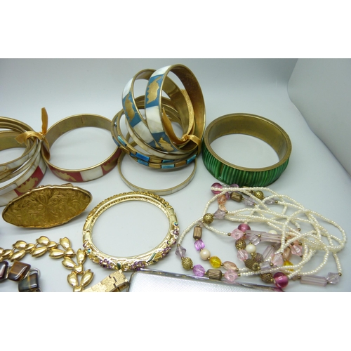 952 - A collection of costume jewellery including bangles, a Montine wristwatch, earrings, case, etc.