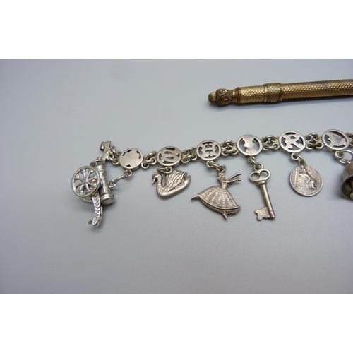 961 - A gold plated propelling pen and a charm bracelet, a/f