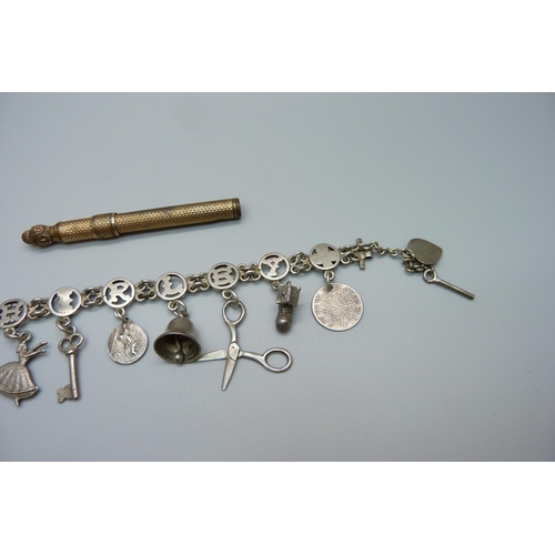 961 - A gold plated propelling pen and a charm bracelet, a/f