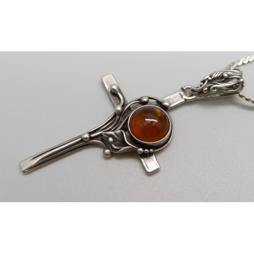 986 - A silver and amber cross pendant, a sterling brooch and an Alpaca Mexico brooch