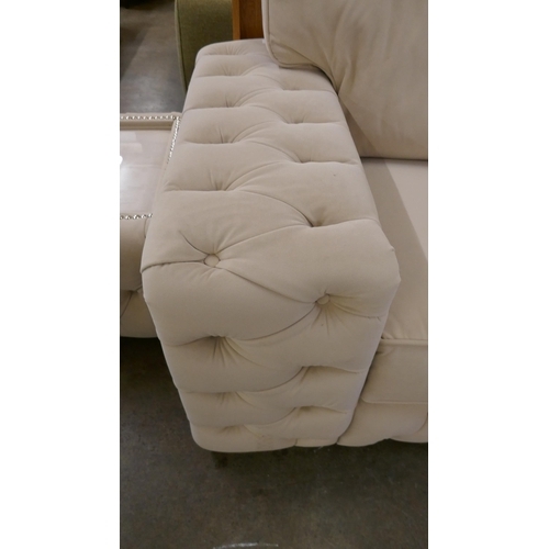 1527 - A cream three seater sofa bed and glass topped coffee table